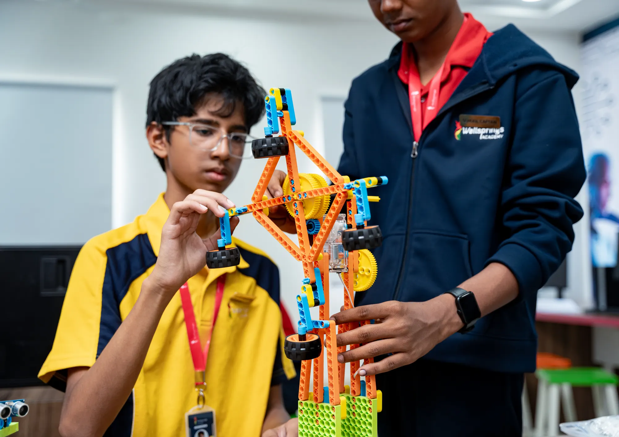 A Wellsprings student and a teacher building a model in the STEAM lab