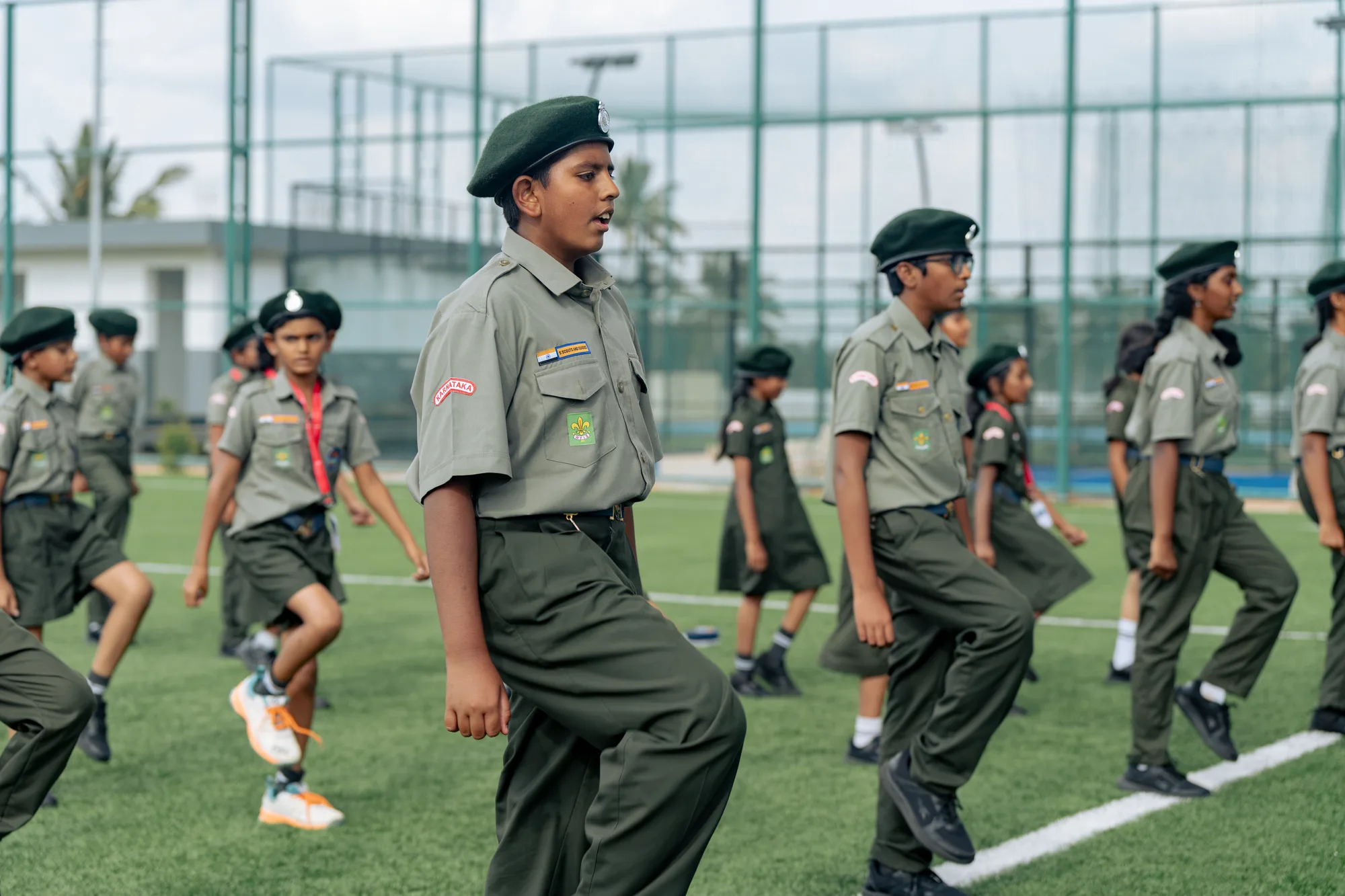 Wellsprings scouts marching on the field in uniform