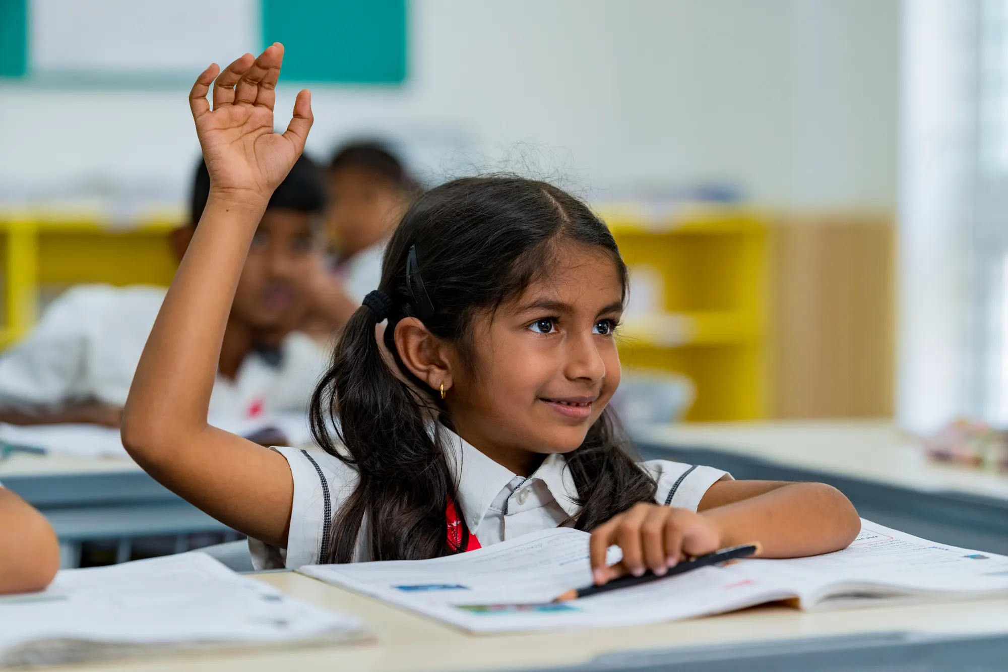 A hand raised in class
