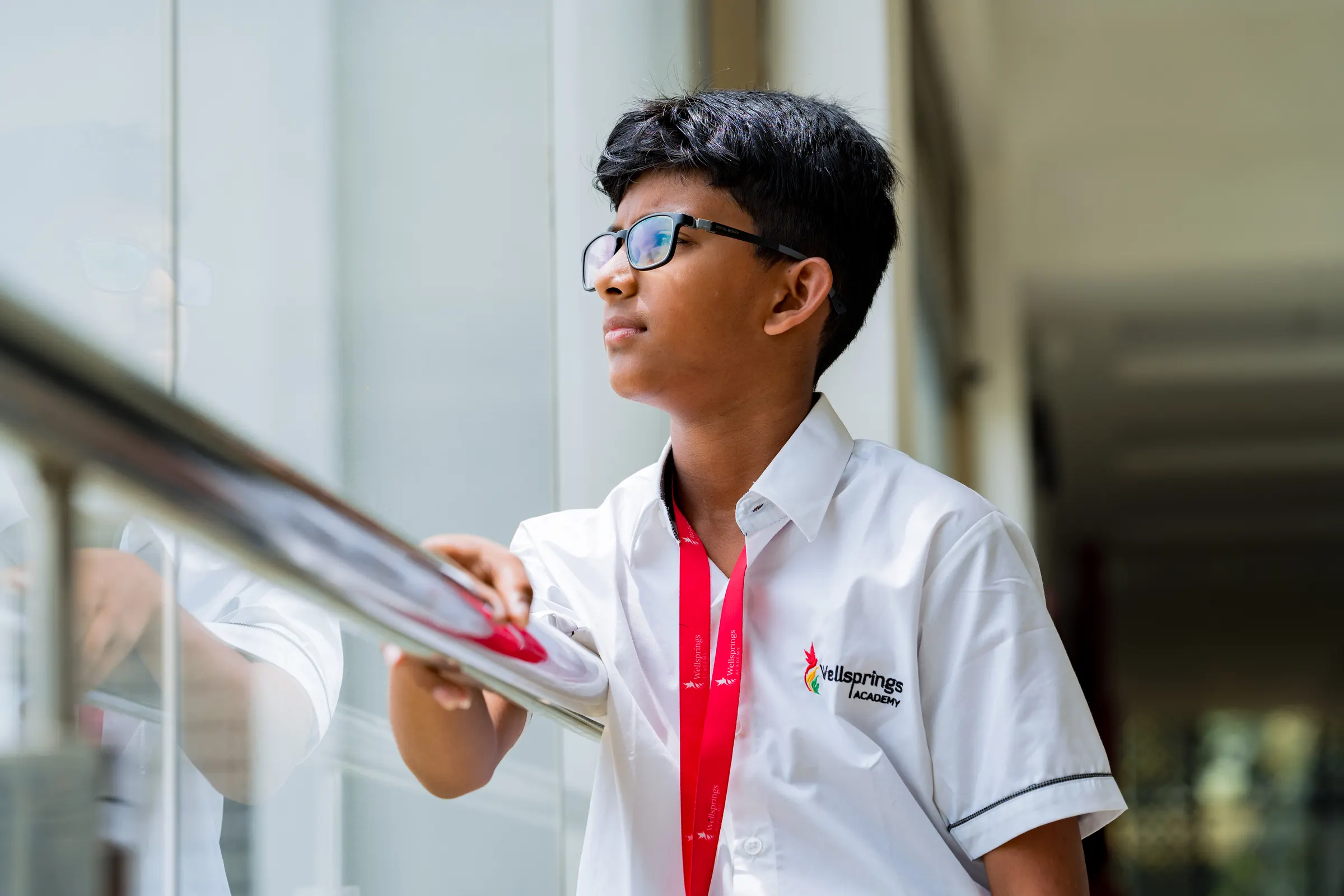 A Wellsprings student looking out from a balcony