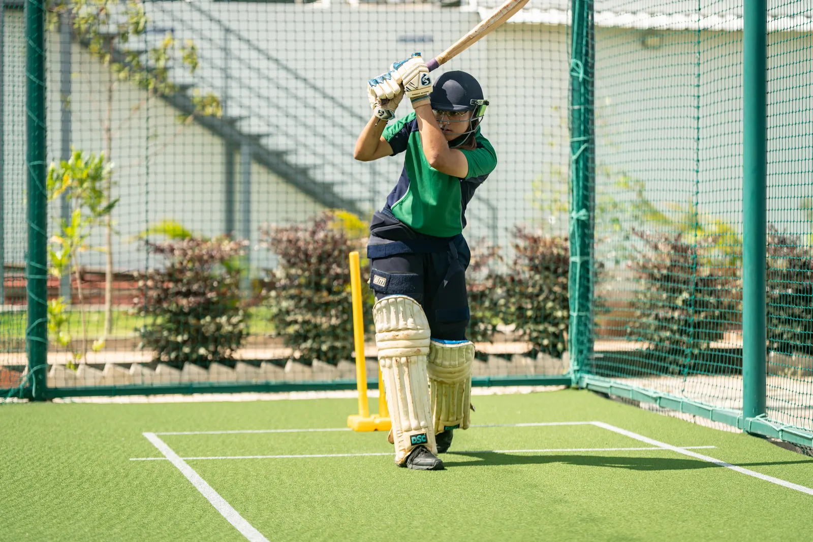 A Wellsprings student batting in the cricket nets