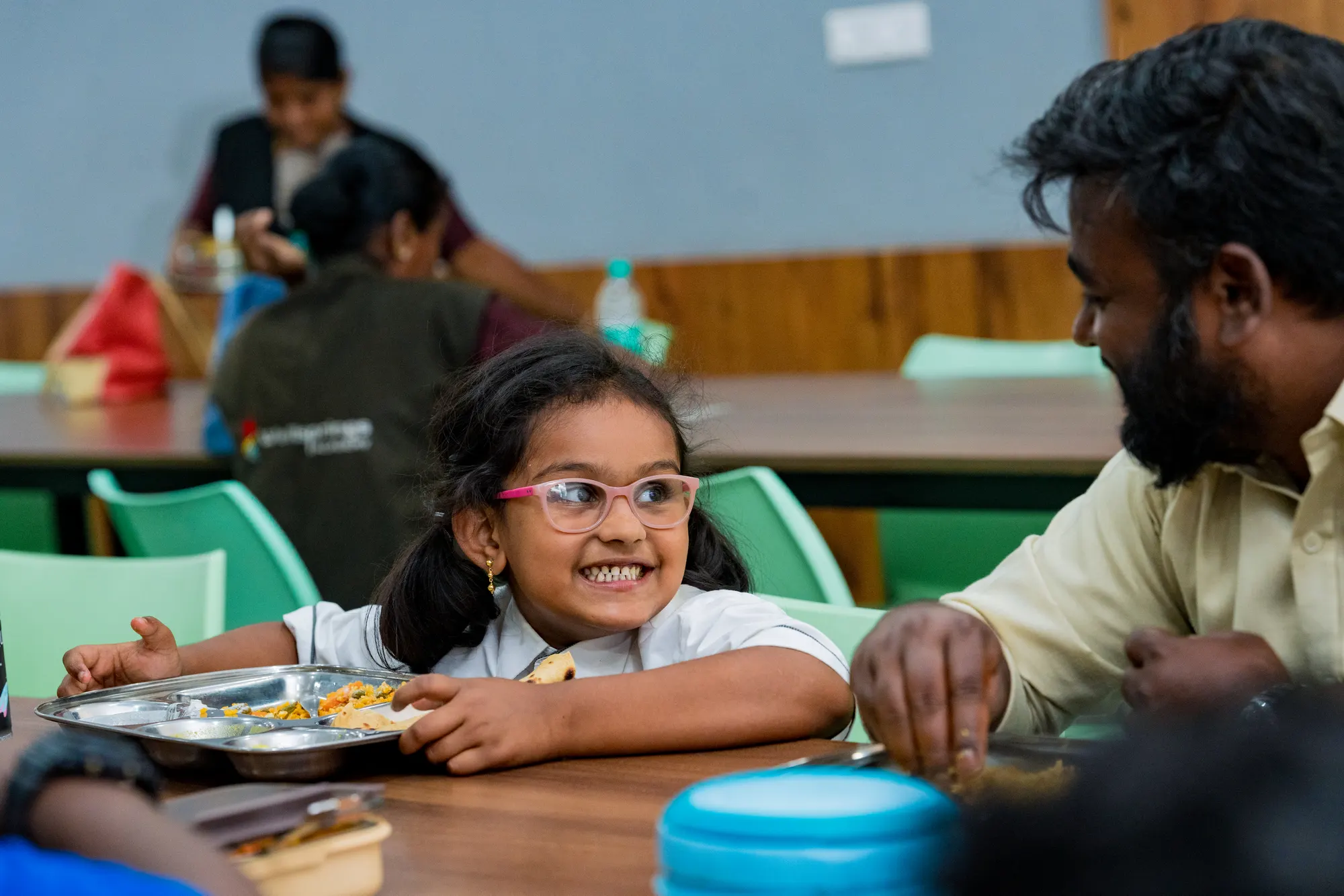 A Wellsprings student smiling over breakfast