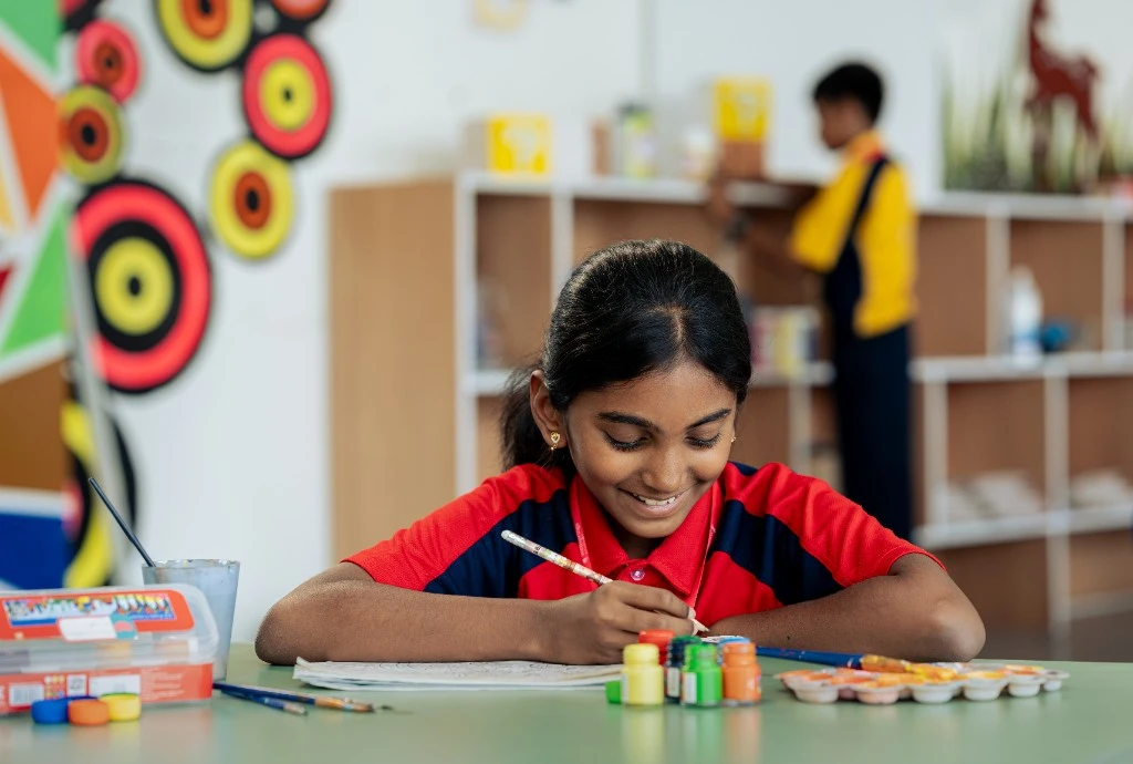 A Wellsprings student drawing at a table