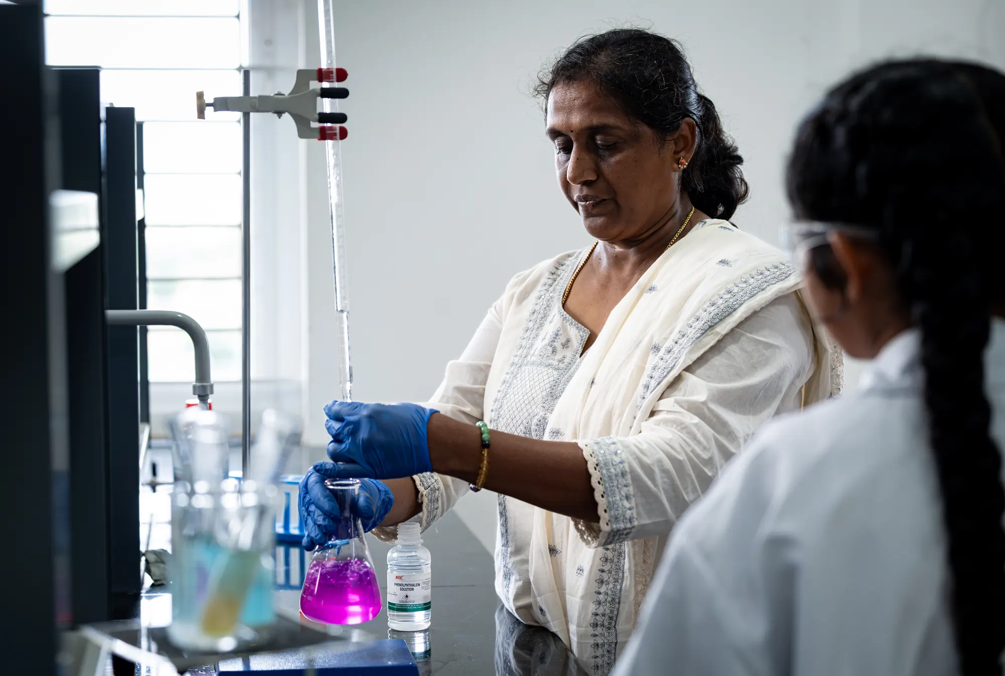 A teacher pouring liquid in the science laboratory